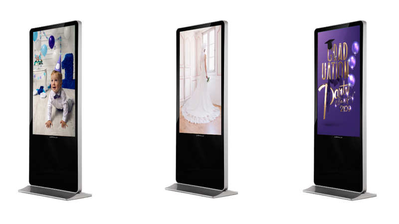 Three digital kiosks showing different content types including children's party, wedding dress, and graduation announcement