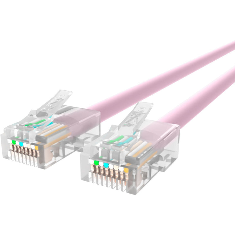 Close-up view of transparent RJ45 connectors on pink CAT5e ethernet cable showing internal wiring