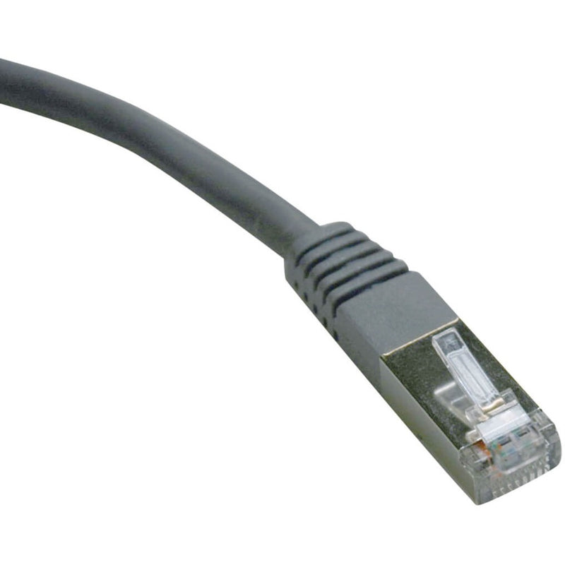 Close-up view of Tripp Lite Cat6 FTP patch cable's gray RJ45 connector with strain relief boot and gold-plated contacts