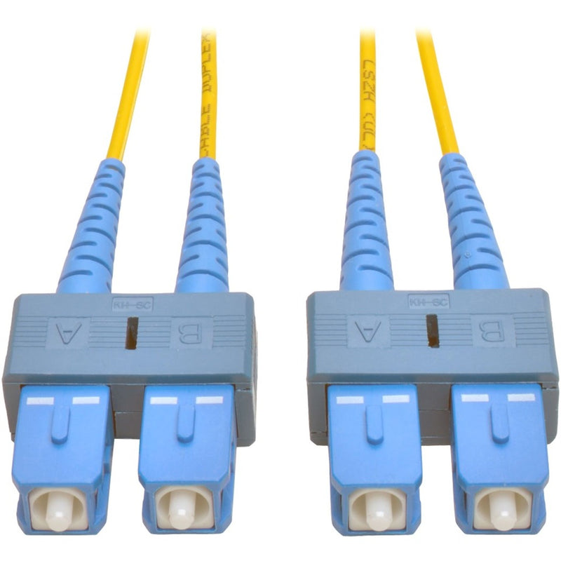 Close-up view of Tripp Lite N356-10M fiber optic cable showing yellow jacket and blue SC connectors at both ends