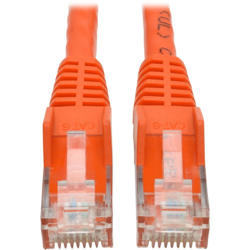 Close-up view of orange Cat6 cable RJ45 connectors with gold-plated pins and strain relief boots