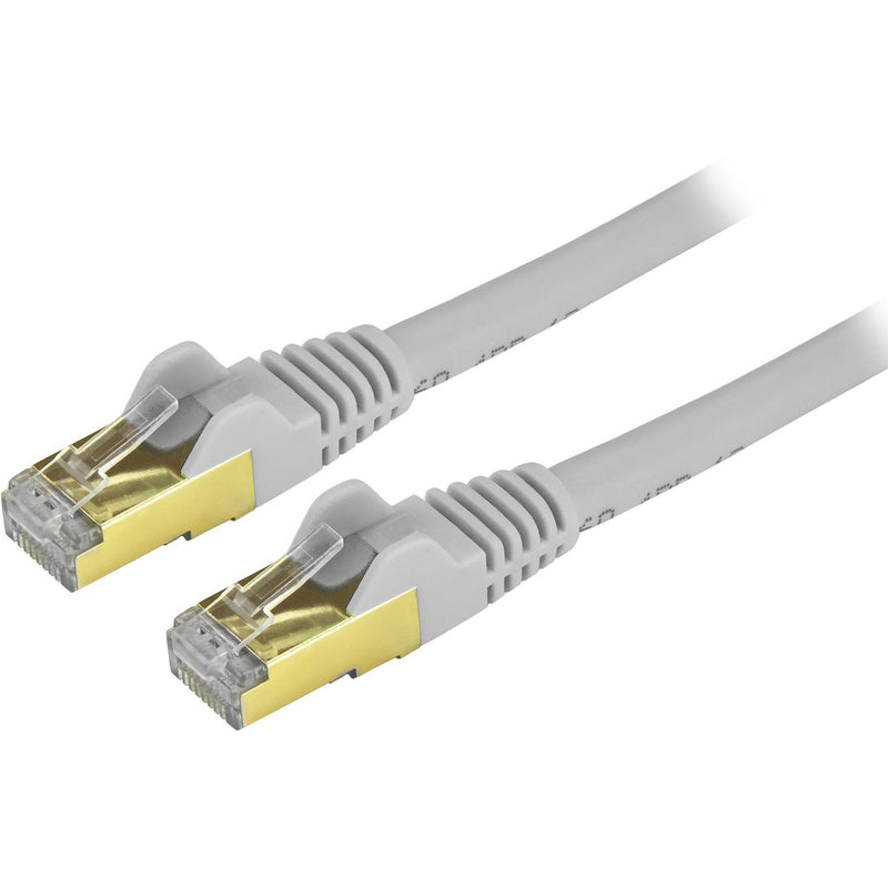 Close-up view of StarTech.com Cat6a cable's gold-plated RJ45 connectors with gray strain relief boot and yellow metallic shield