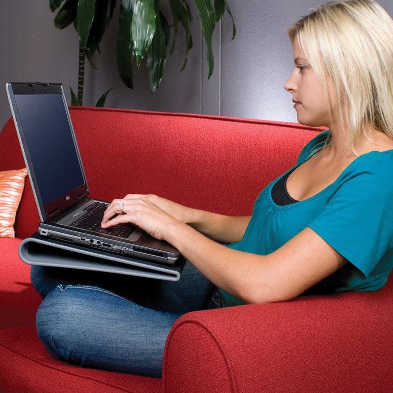 Person comfortably using laptop with Targus Chill Mat on couch-alternate-image10