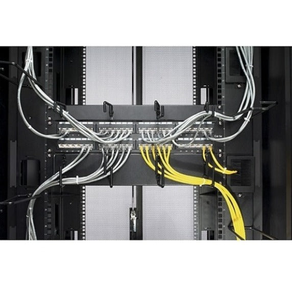 Cable organizer in use showing organized network cables in white and yellow running through management hoops