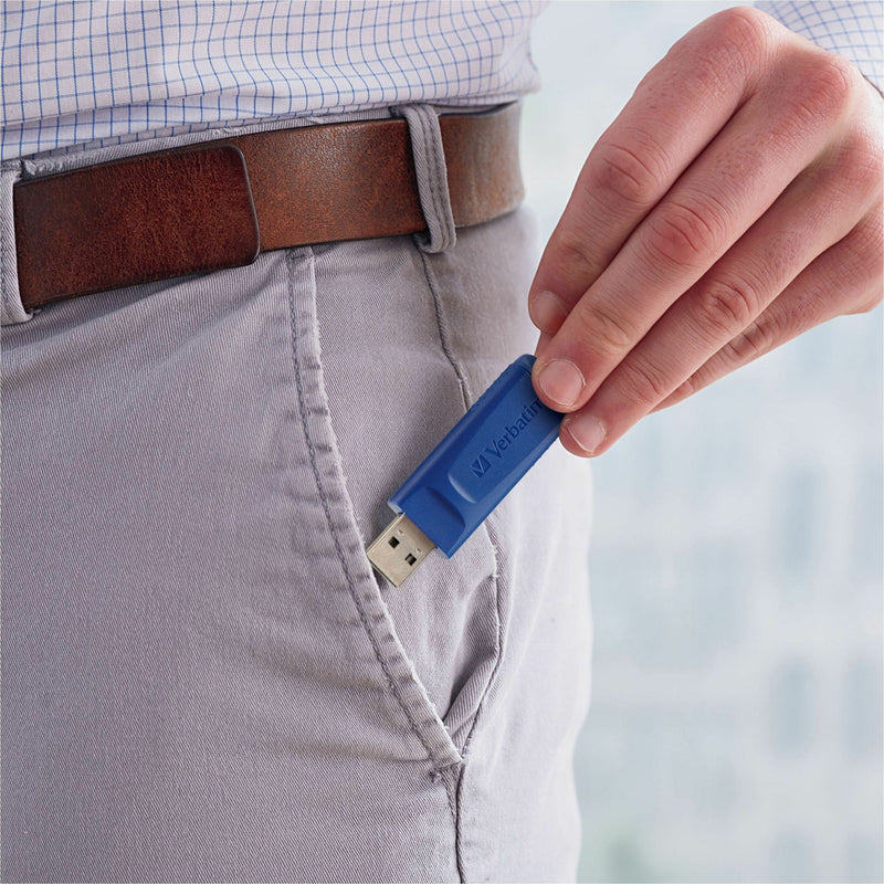 Verbatim USB drive being held near pocket showing its portable size