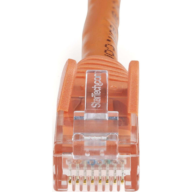 Macro shot of orange Cat6 cable RJ45 connector showing StarTech.com branding and gold-plated pins