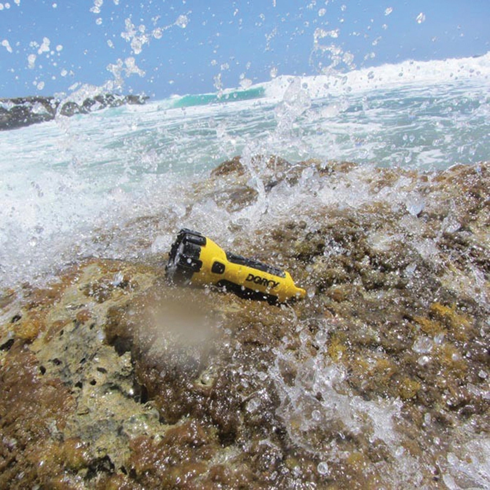 Dorcy flashlight being splashed by ocean waves demonstrating waterproof capability-alternate-image6