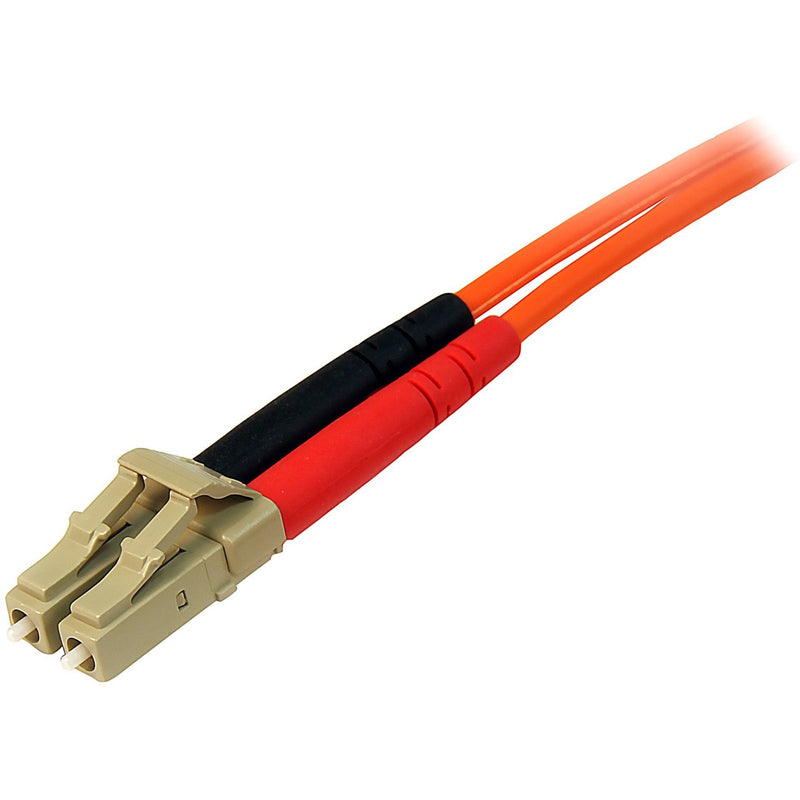 Detailed view of LC connector with red and black strain relief boots on orange fiber cable