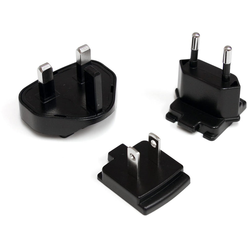 Detailed view of three interchangeable power plug adapters for different regions