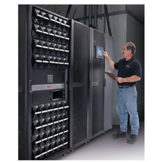 APC service technician performing diagnostic checks on a large-scale UPS system with battery frame installation