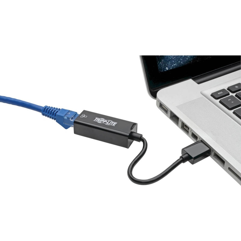 Tripp Lite Ethernet adapter connected to laptop USB port with network cable attached