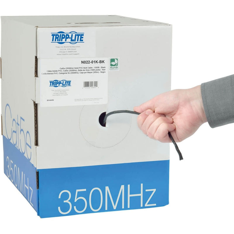 Tripp Lite branded box showing cable specifications and RoHS compliance with cable being pulled