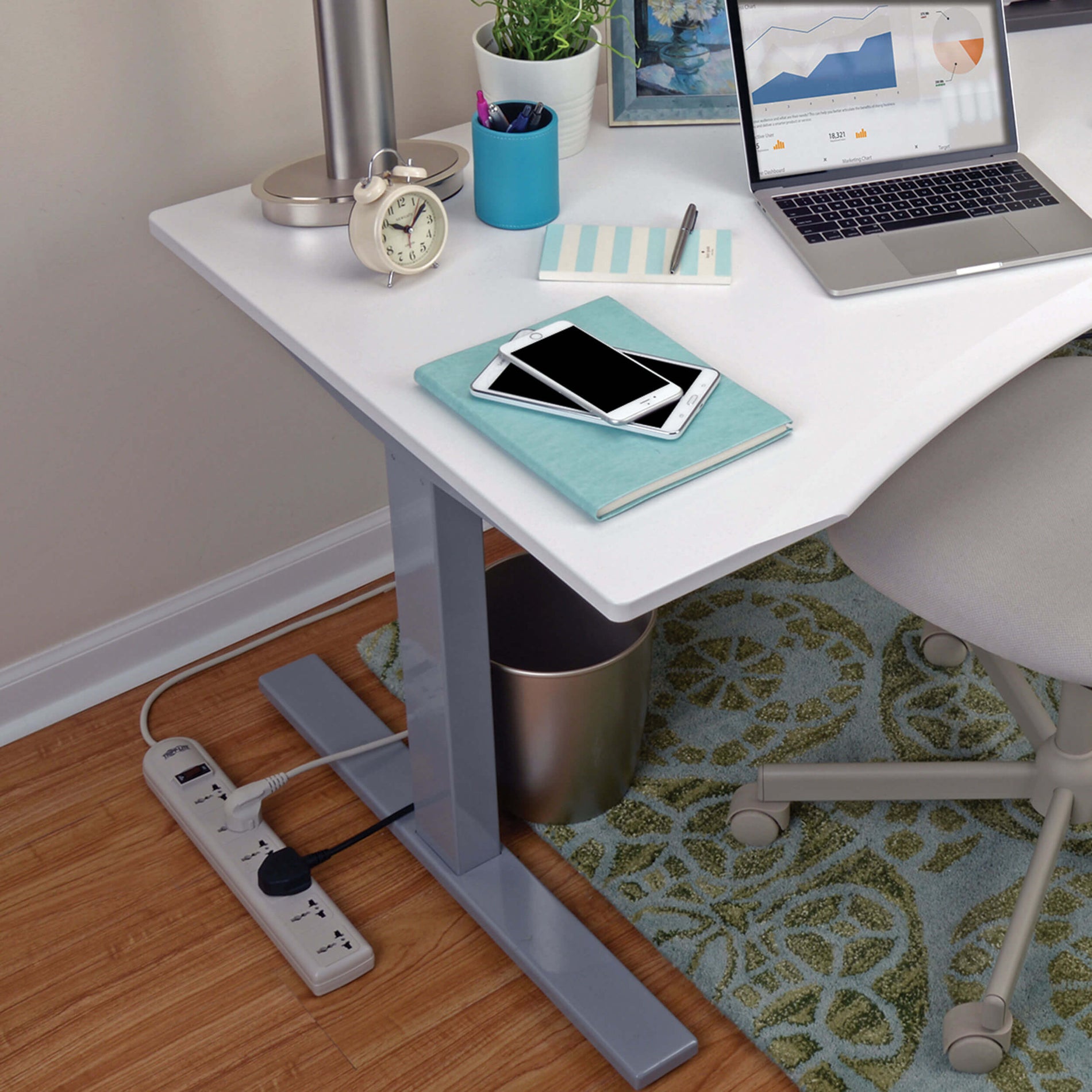 Lifestyle image showing Tripp Lite surge protector in use under a modern desk setup-alternate-image3