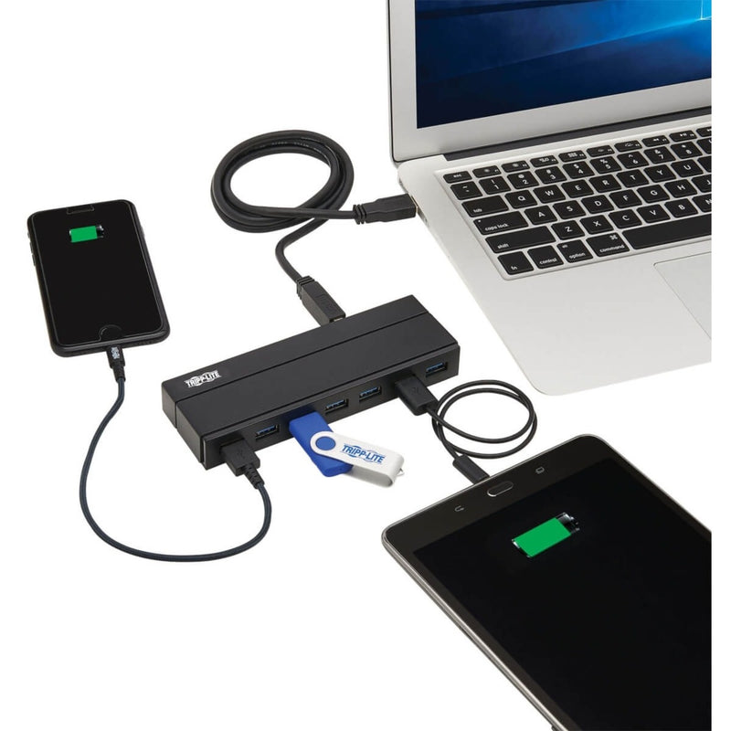 Tripp Lite USB hub connected to laptop with multiple devices including smartphone and flash drive