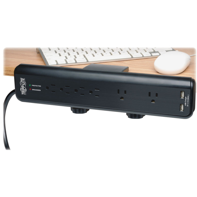 Top view of Tripp Lite surge protector mounted under desk showing LED indicators and outlets