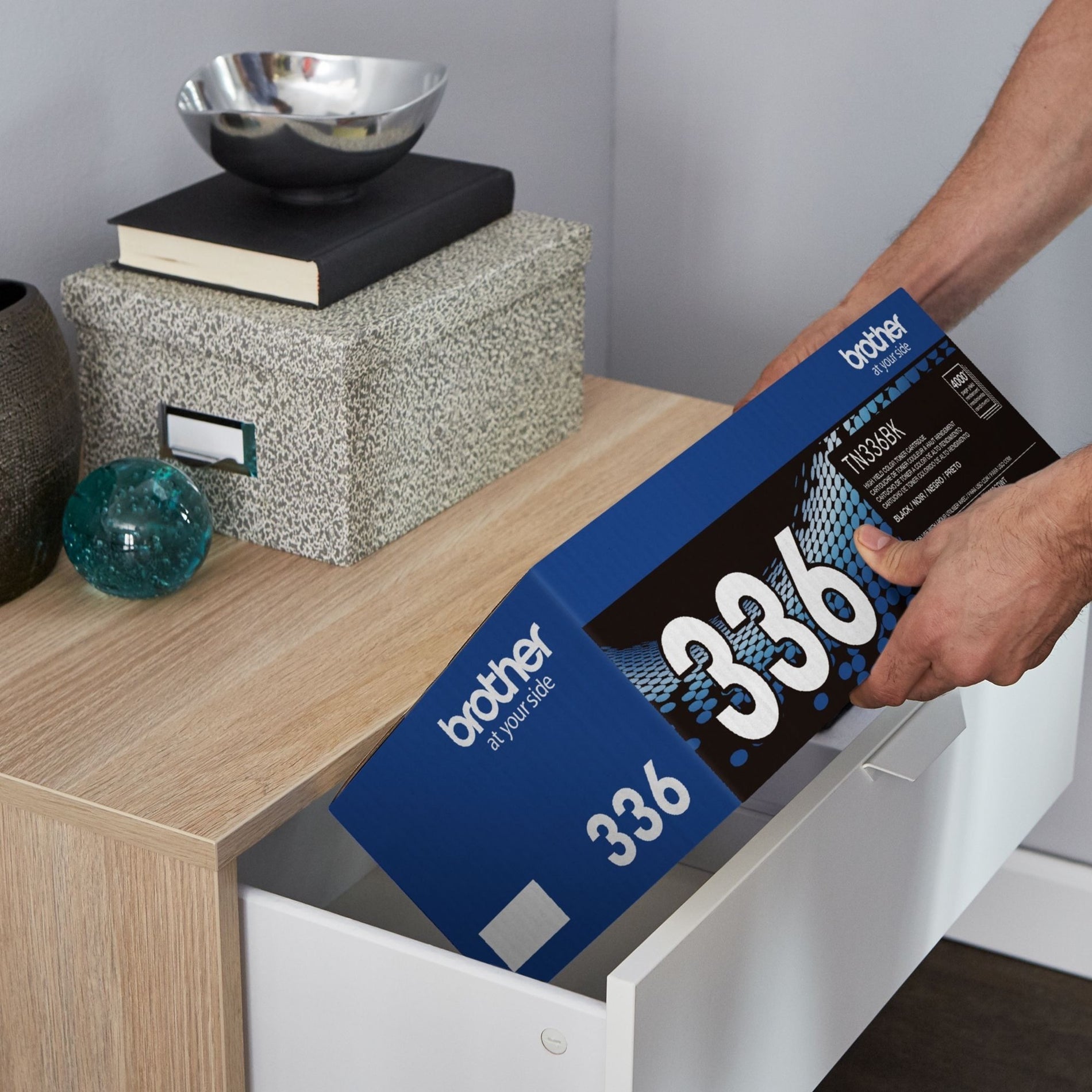 Brother toner cartridge being stored in office cabinet showing practical storage solution-alternate-image5