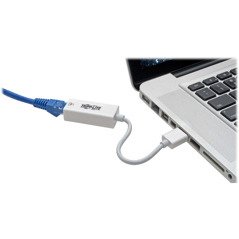 Tripp Lite network adapter connected to laptop USB port with Ethernet cable