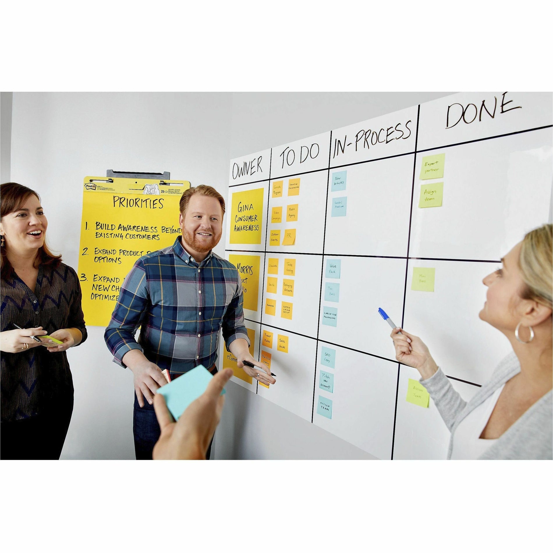 Team collaborating at a whiteboard with Post-it Dry Erase Accessory Tray mounted nearby-alternate-image4