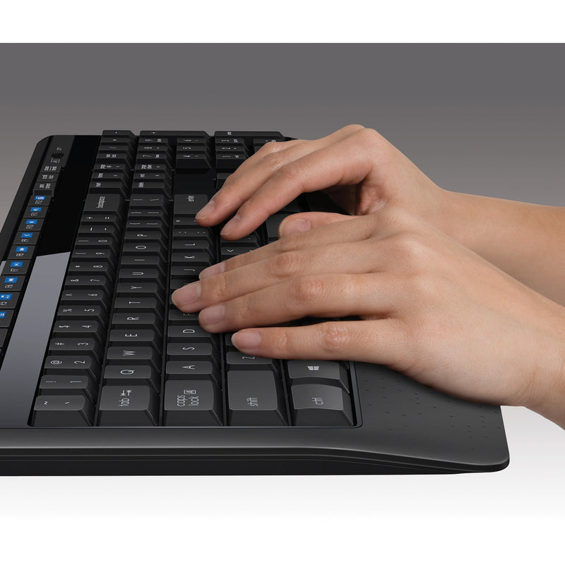 Close-up of hands typing on Logitech MK345 keyboard showing ergonomic design