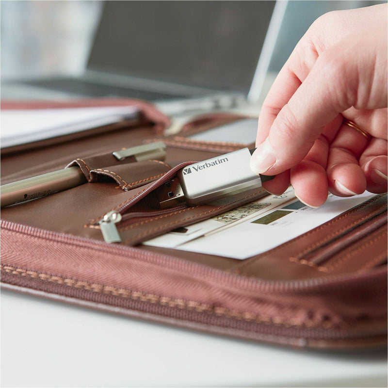 Verbatim Secure Pro USB drive being used with leather portfolio in professional setting