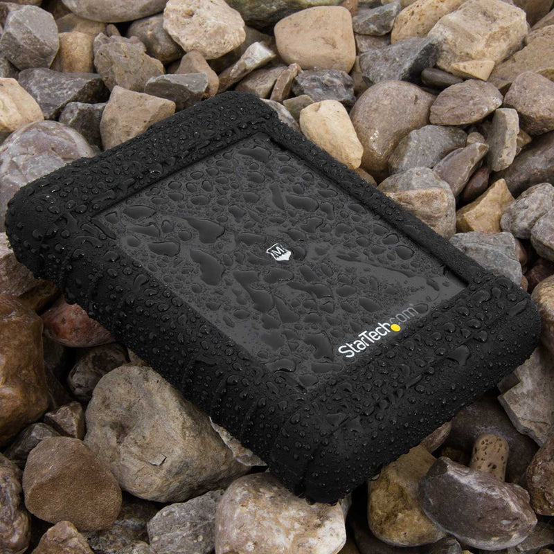 Water droplets beading on the surface of the rugged drive enclosure placed on rocky terrain