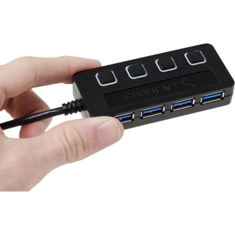 Hand holding Sabrent USB hub showing size perspective and ergonomic design