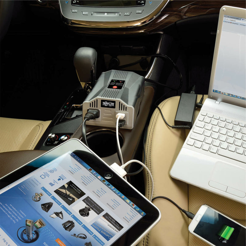 Tripp Lite PV200USB in use powering multiple devices in a car setting including laptop, tablet and smartphone