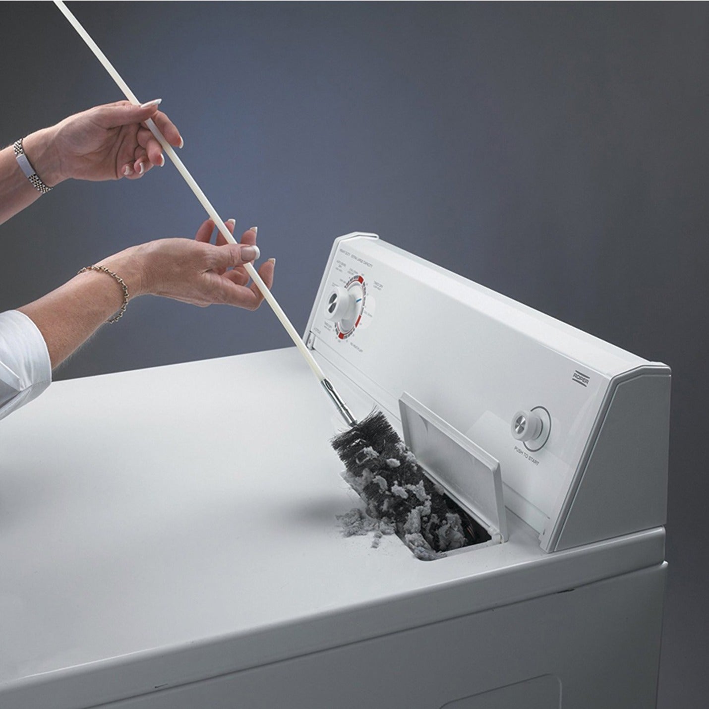 Hands demonstrating use of LintEater system from inside dryer access point-alternate-image9