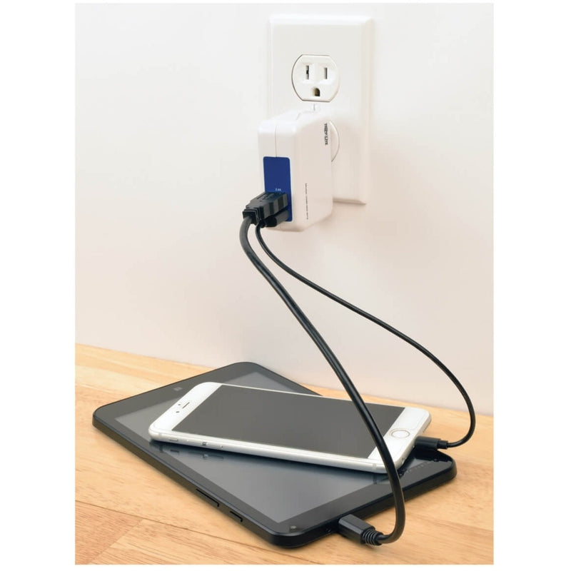 USB wall charger in use charging tablet and smartphone simultaneously