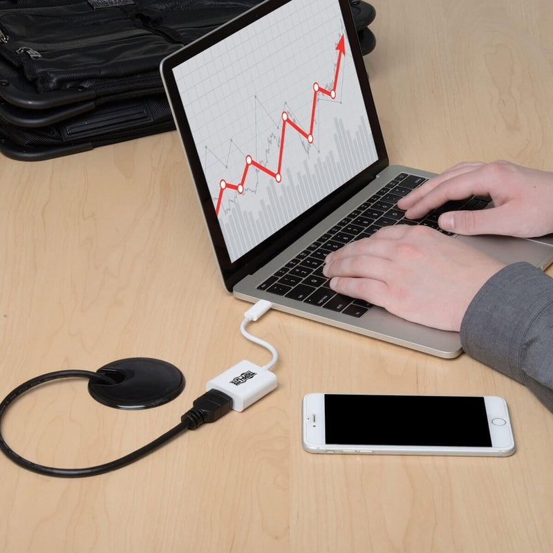 Close-up of laptop workspace with Tripp Lite adapter