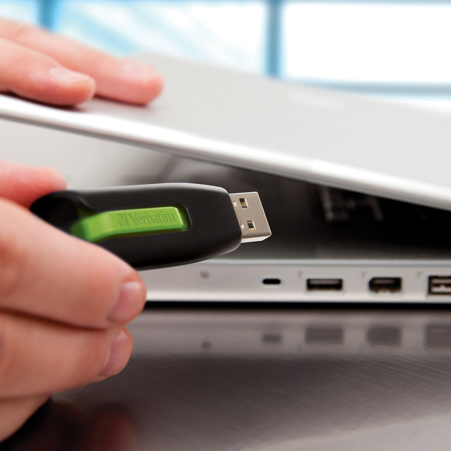 Green USB drive being inserted into laptop port-alternate-image11