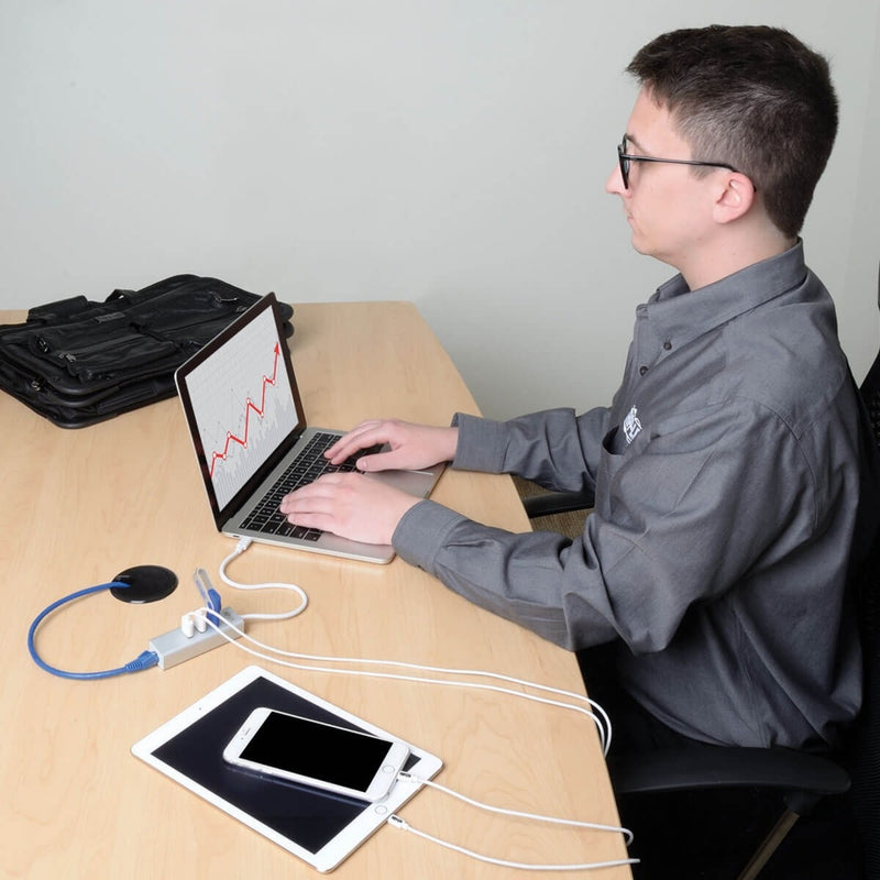 Professional using Tripp Lite USB-C hub with laptop and multiple connected devices