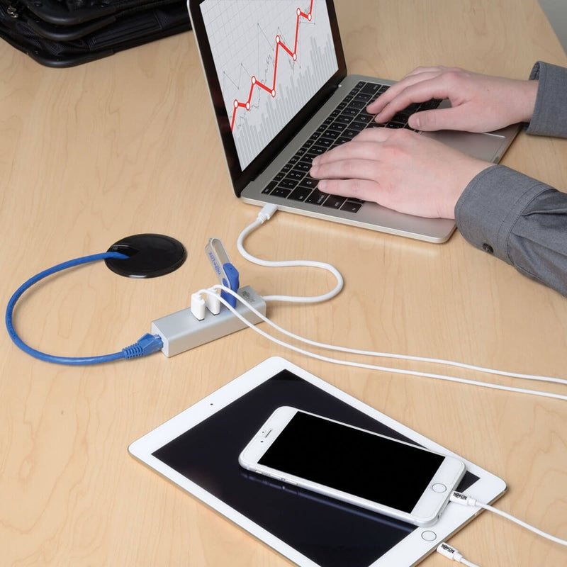 Close-up view of Tripp Lite USB-C hub connected to laptop with multiple devices