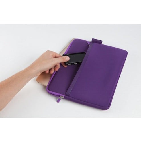 Belkin USB-C hub being placed into a purple laptop sleeve, demonstrating portability