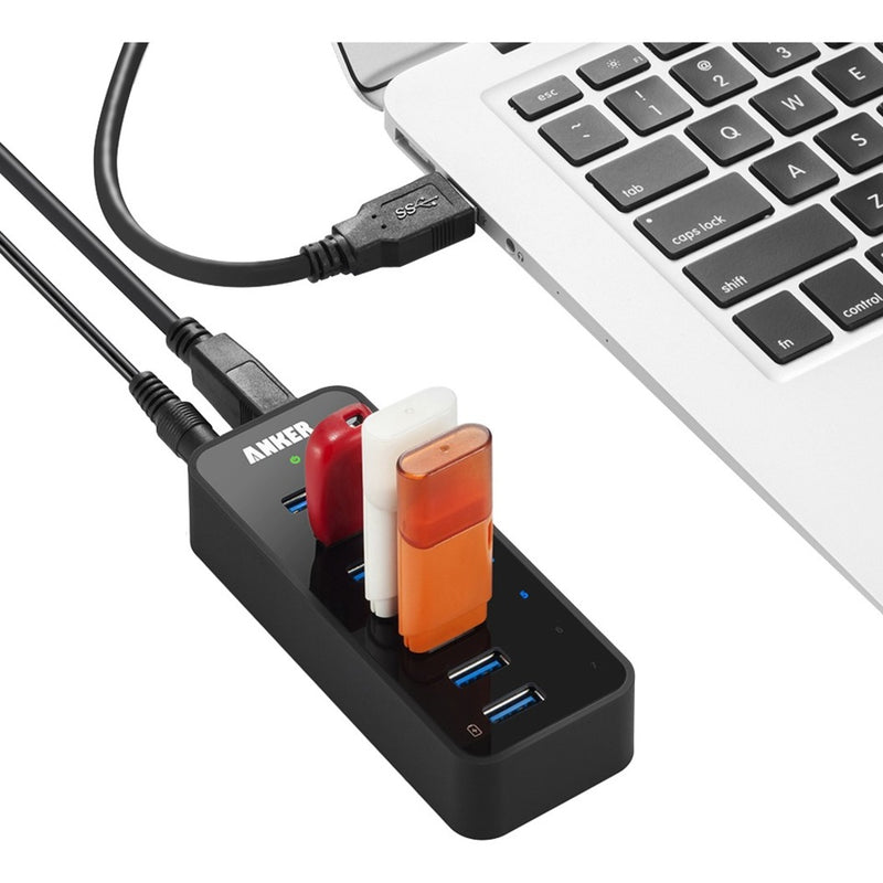 Anker USB hub connected to laptop with multiple USB drives attached