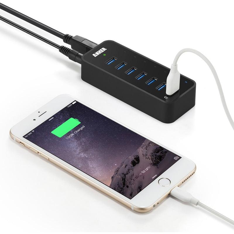 Anker USB hub charging an iPhone with charging status display