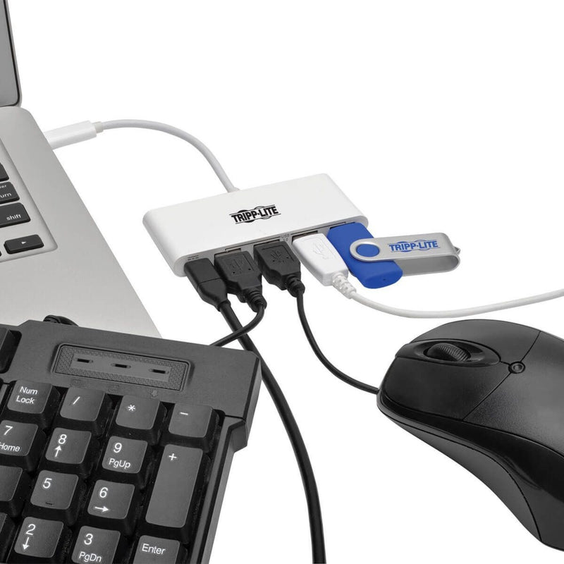 USB hub connected to laptop with keyboard, mouse, and USB drive attached