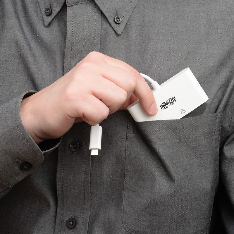 Person holding Tripp Lite adapter near shirt pocket