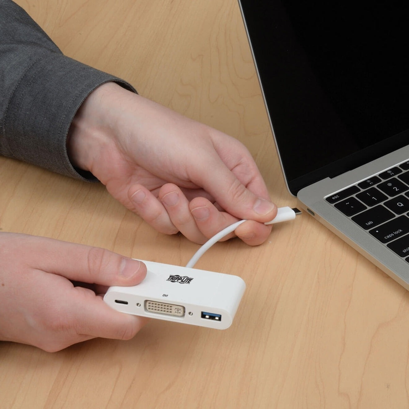 Close-up of hands connecting Tripp Lite adapter to laptop USB-C port-alternate-image4