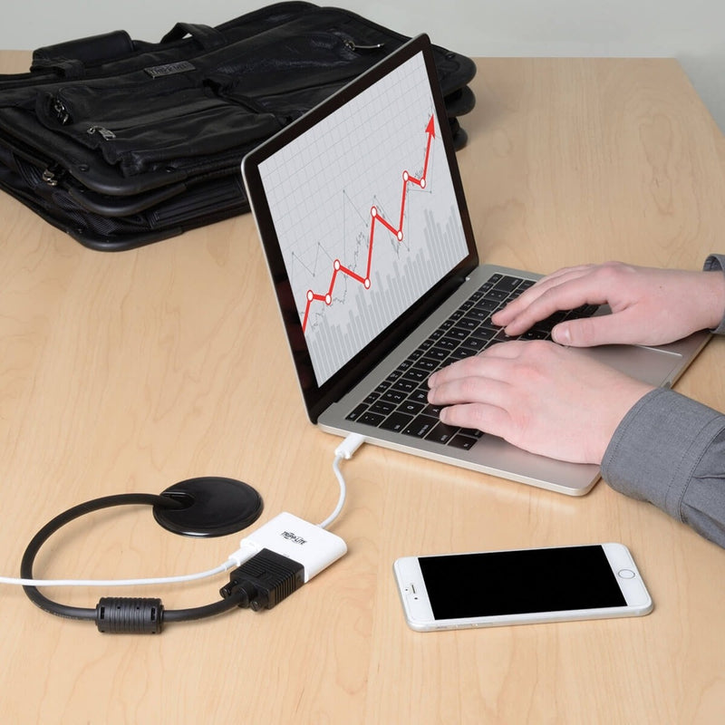 Close-up of laptop connected to VGA adapter showing data visualization