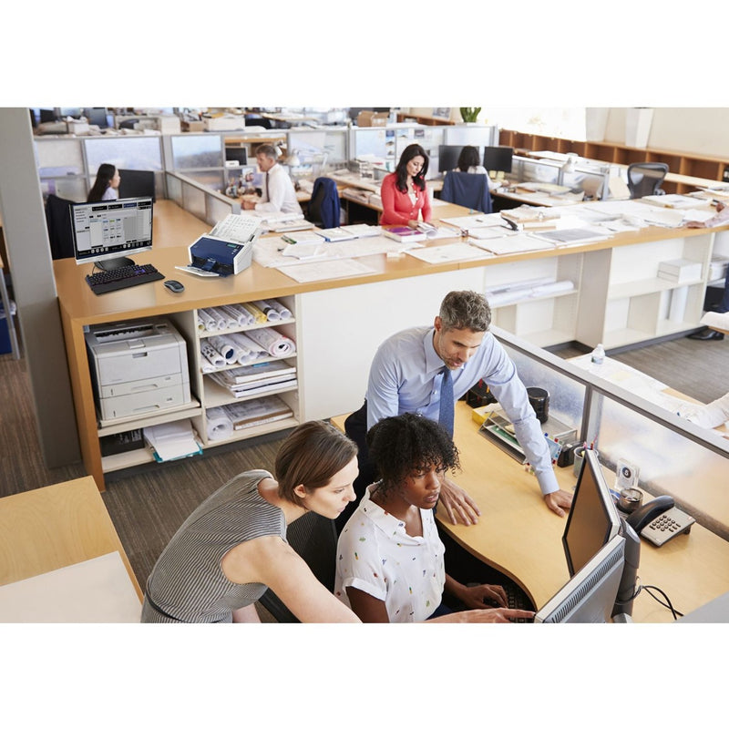 Office environment showing team members working with DocuMate 6440 scanner