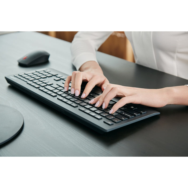 Close-up view of hands typing on Lenovo wireless keyboard