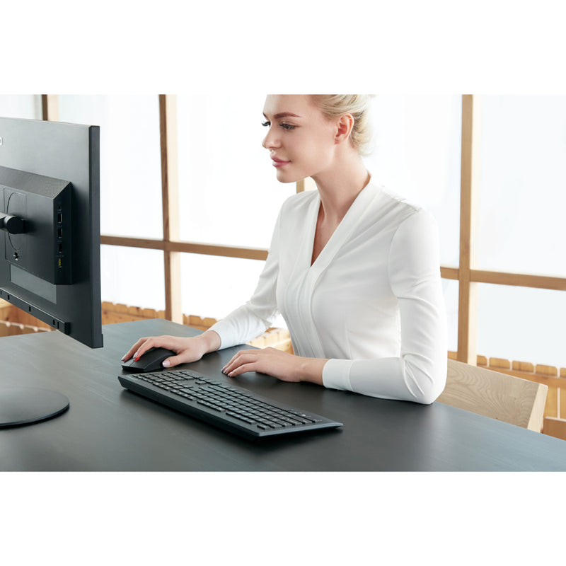 Close-up of professional using Lenovo wireless keyboard in office setting