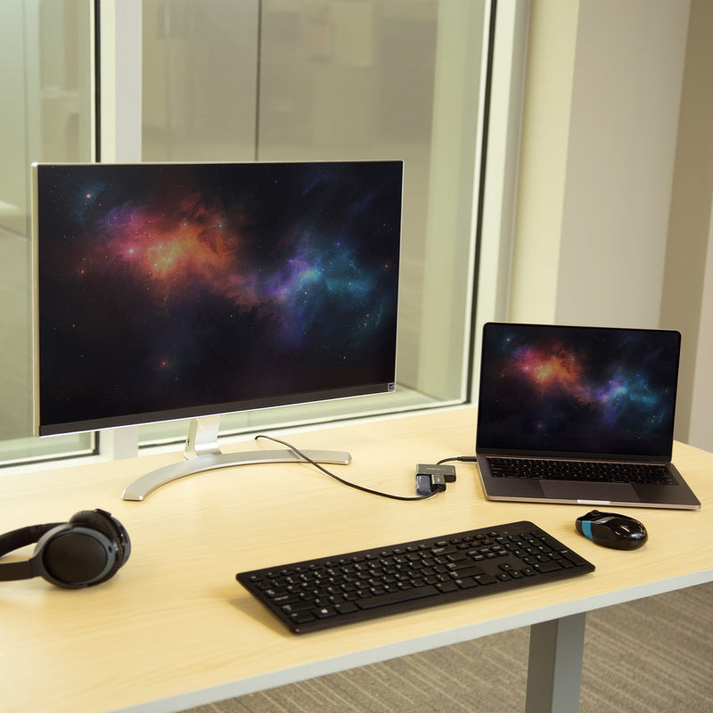 Desktop setup showing laptop connected to 4K monitor via StarTech.com adapter with keyboard and mouse