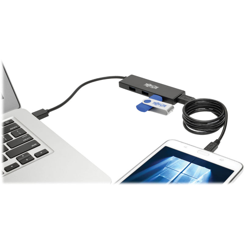 Tripp Lite USB hub connected to laptop with smartphone and flash drive demonstrating multi-device connectivity