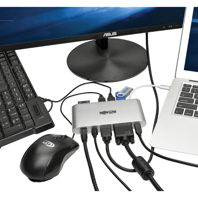 Tripp Lite docking station connected to laptop, monitor, keyboard, and mouse in office setting