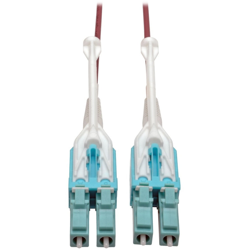 Close-up view of dual LC fiber optic connectors with white push/pull tabs and turquoise connector bodies