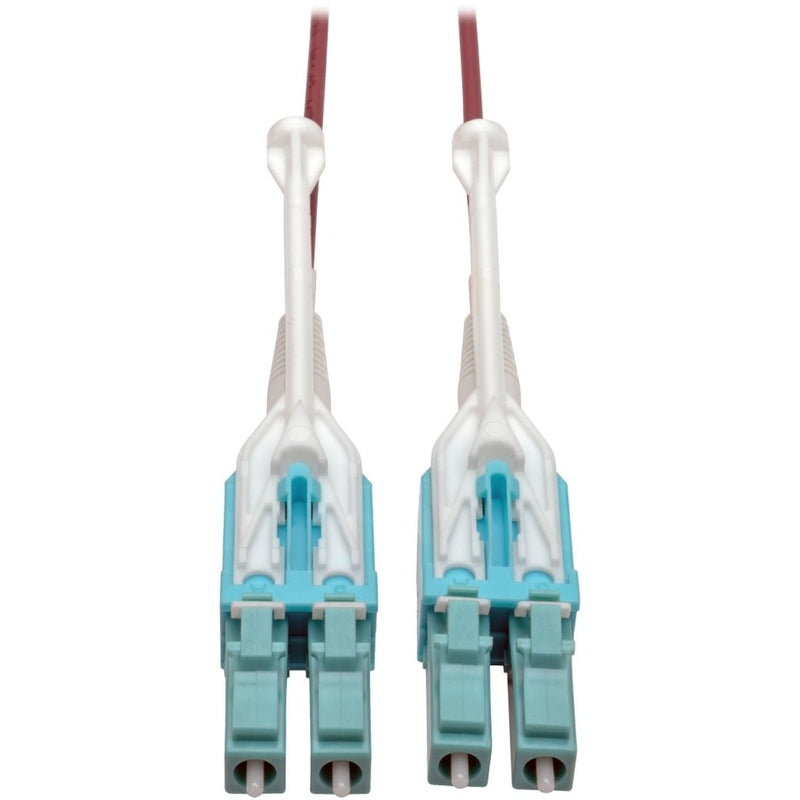 Close-up view of dual LC fiber optic connectors with white push/pull tabs and turquoise connector housing