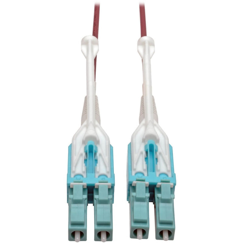 Close-up view of dual LC fiber optic connectors with turquoise housing and white push-pull tabs