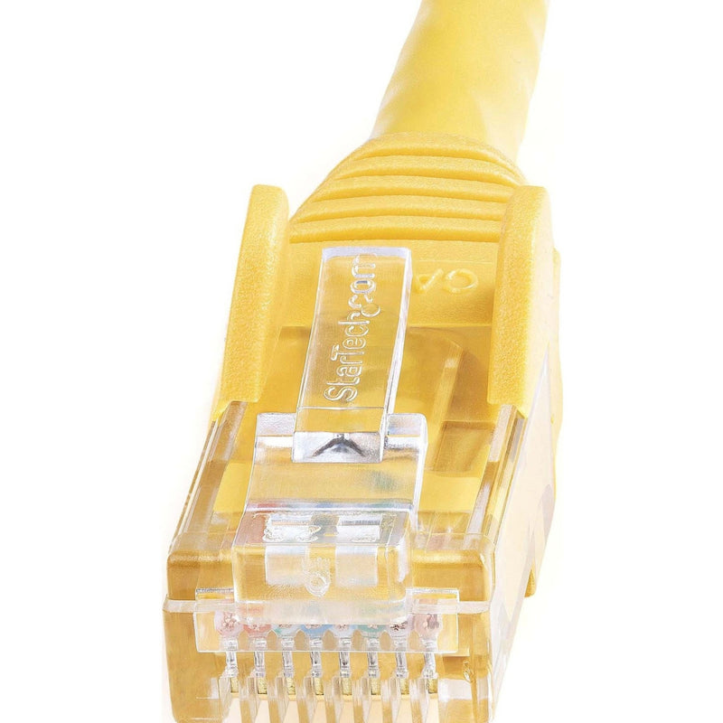 Detailed macro shot of StarTech.com branded RJ45 connector showing internal components and yellow housing